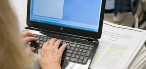 hand on a laptop computer