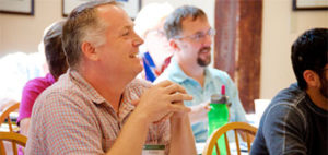smiling adult males in classroom