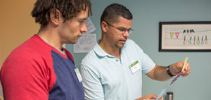 two adults looking over a piece of paper