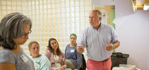 teacher talking to a group of adult students