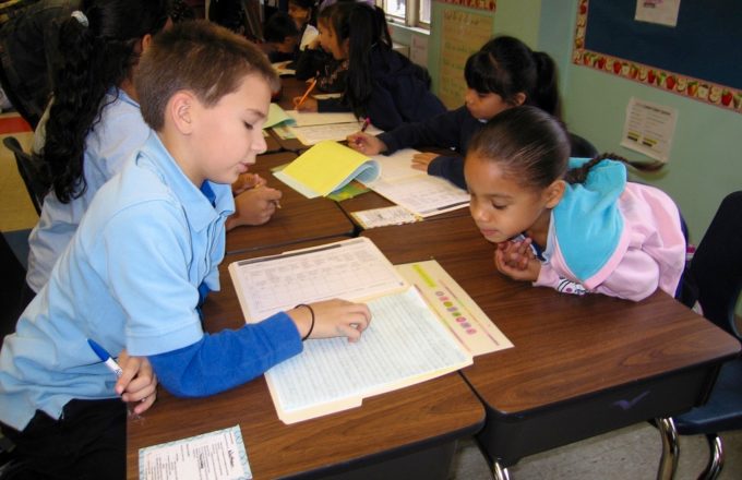 Two students work together at a desk