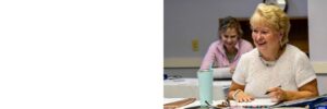 Woman sitting at a desk, smiling