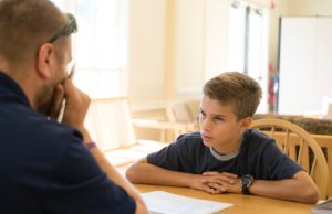 A student and a teacher having a discussion at a table