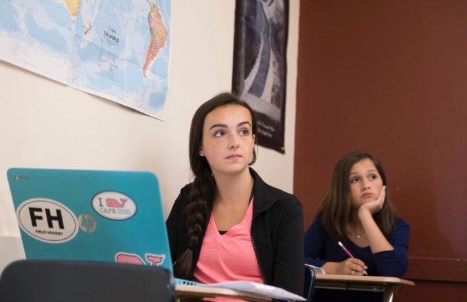 Girl using computer technology in a classroom