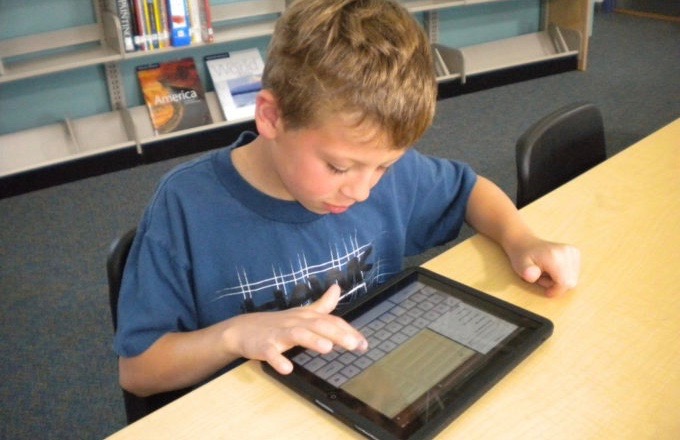 A young boy using technology to support his learning