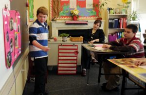 A teacher and a student work together in a classroom