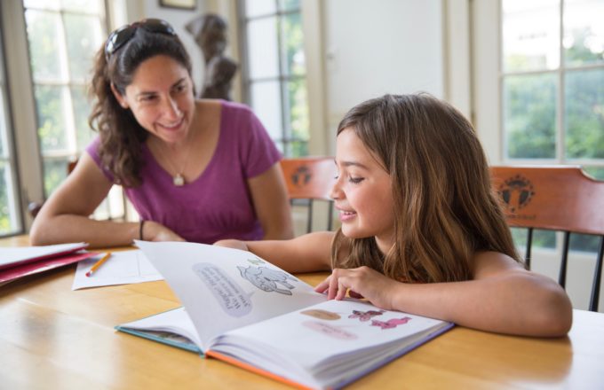 A young girl and a young woman work together