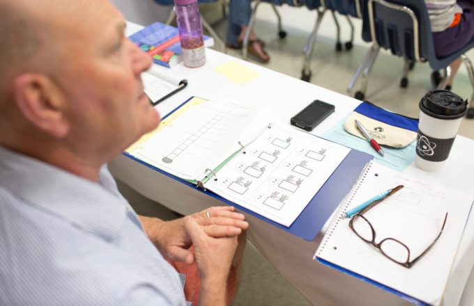 A person working over a math worksheet