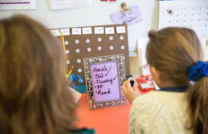 Student and teacher reviewing a class routine