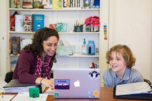 teacher and student in front of a laptop