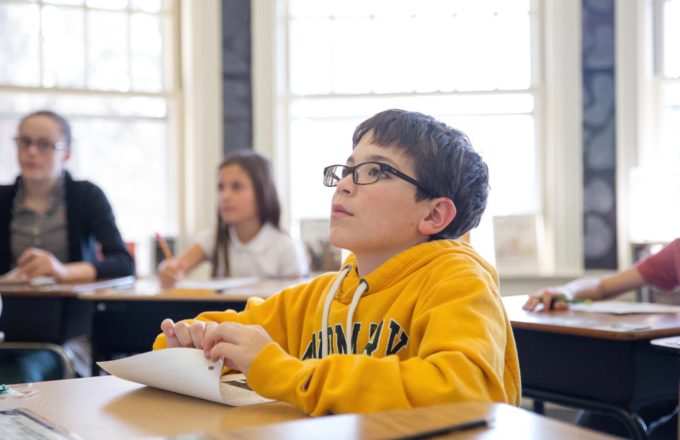 A boy reading in a classroom