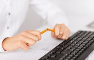 Anxious student breaking a pencil over a keyboard