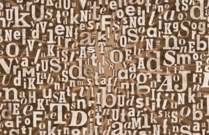 poster of gritty background texture made of old printed letters.