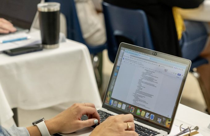 Person typing on a laptop.