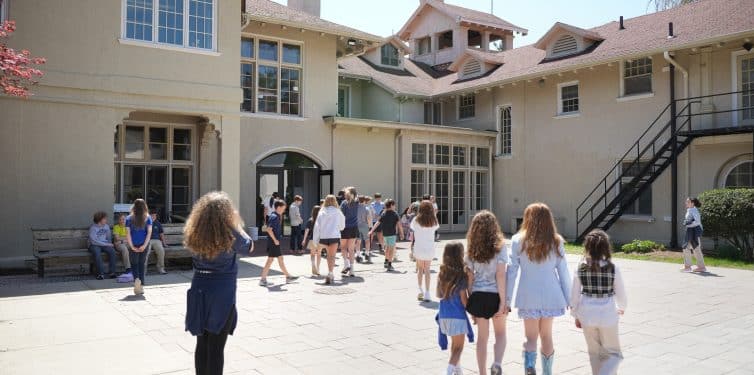 Students walking in schoolyard.