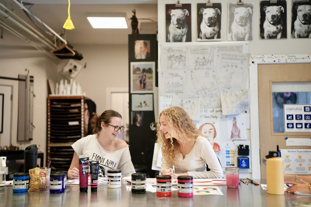 Students working together and smiling.