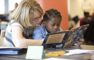 Educator works with student to determine reading ability