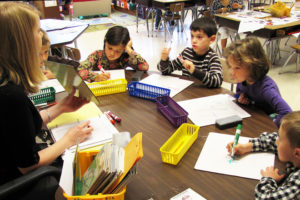 Elementary students practice reading and writing sight words with individual white boards