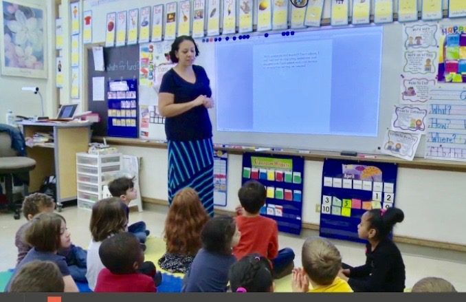 A picture of Marion Ivey in front of her class talking about peer feedback