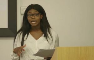 Theresa Awolesi speaking about self-awareness and success in front of a class