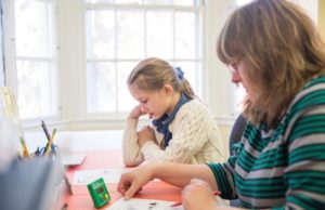 Student and teacher reading in a classroom